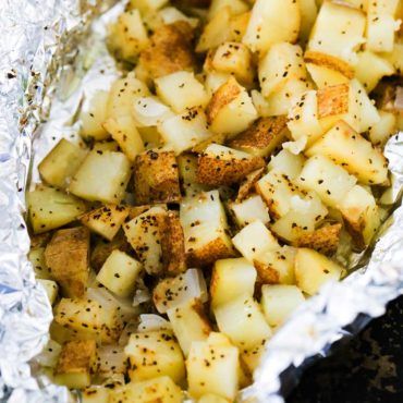 A foil packet filled with cubed roasted potatoes in foil on a baking pan. Foil Grilling Recipes, Diced Potatoes In Oven, Grilling Recipes Foil Packets, Foil Potatoes, Potato Packets, Fish Sides, Foil Packet Potatoes, Steak Burger, Food Sides