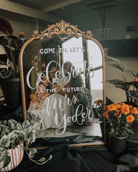 A recent review from the mother of the bride to be: "Everyone absolutely loved the mirror! It was just what we wanted. It added a special touch to the party! Thank you 🫶🏻" A hand lettered vintage mirror makes an elegant sign for a bridal shower or wedding. Did you know you can rent a gold framed mirror with custom lettering? Visit www.keturahstoltzfus.com and see all the mirrors available for your event. Glam Vintage Wedding, Gold Mirror Bridal Shower Sign, Rehearsal Dinner Mirror Sign, Vintage Frame Wedding Sign, Bridal Shower Fireplace, Bridal Shower Mirror Sign, Bridal Shower Mirror, Mirror Welcome Sign Wedding, Mirror For Wedding