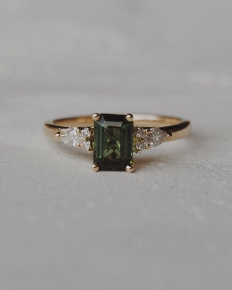 Congratulations Quin + Rae 🥹💍🍾 We customized our Elsie setting, switching out the centre stone for a stunning 6x4mm natural dark green tourmaline with pear and round accents. We wish you the best for your engagement season!! Engagement photos by the lovely: @jordanfayephotography Dark Diamond Ring, Color Stone Engagement Ring, Green Topaz Ring, Dark Green Sapphire Engagement Ring, Natural Engagement Ring, Dark Emerald Engagement Ring, Green Gold Engagement Ring, Dark Green Engagement Ring, Engagement Rings Green Stone