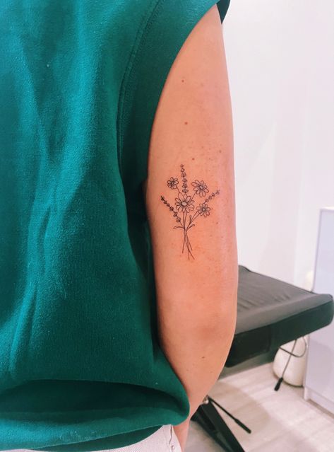 Unique Flower Tattoos Small, Feminist Flower Tattoo, Dainty Daisy Bouquet Tattoo, Flowers Around Writing Tattoo, Back Of Arm Simple Tattoo, Tattoo Ideas For Back Of Arm Women, Flower On Back Of Arm Tattoo, Small Back Tattoos Flowers, Tattoo Ideas Female Flower Simple