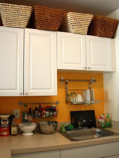 excellent use of limited space in a studio kitchen: grundtal dish and spice racks, wicker baskets above cabinets Baskets Above Kitchen Cabinets, Desert Kitchen, Apartment Therapy House Tours, Shop Houses, Decorating Above Kitchen Cabinets, Apt Decor, Deco House, Above Kitchen Cabinets, Above Cabinets