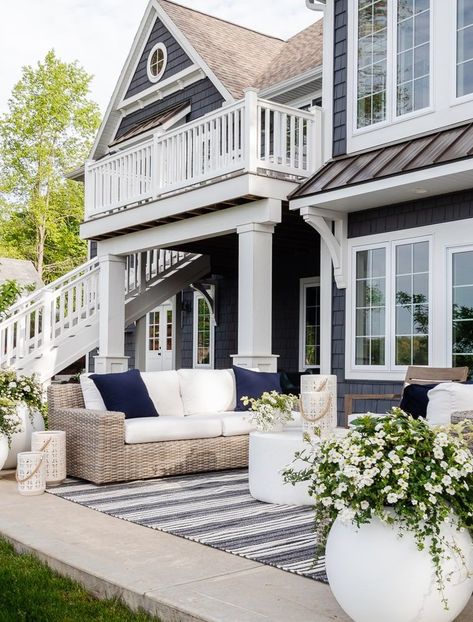 grey outdoor wicker sofa, striped rug, cement coffee table white planters Lilypad Cottage, Large Outdoor Planters, Patio Plans, Lake Houses Exterior, House Outdoor, Cottage Exterior, Indoor Outdoor Planter, Gorgeous Bedrooms, White Planters