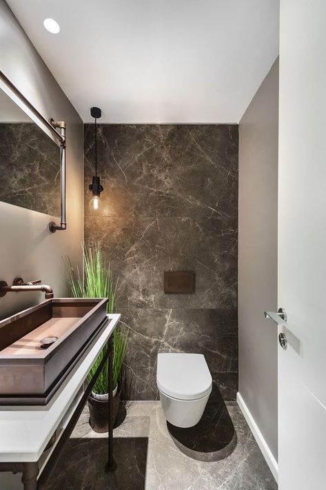 a chic guest toilet with stone tiles, a large metal sink, a fake potted plant and some pipes for an industrial feel Toilet Hotel, Toilet Design Modern, Small Toilet Design, Lavabo Design, Toilet Room Decor, Small Toilet Room, Toilet Sink, Guest Toilet, Contemporary Bathroom Designs