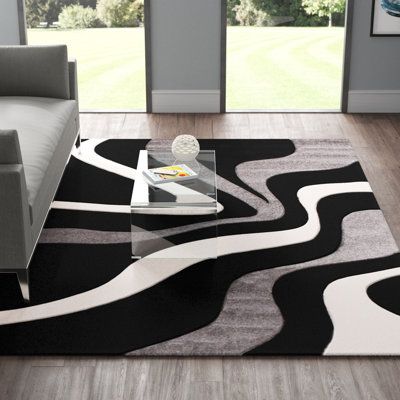 This area rug grounds your space in an abstract print and modern style. It's power-loomed from polypropylene, and it showcases a swirling geometric design in a neutral palette of gray, black, and white hues. With its medium 0.47" pile height, this area rug is ideal for softening your bedroom or living room floors while staying easy to clean. To care for it, simply vacuum it with no beater bar and spot-clean it with mild detergent. Rug Size: Rectangle 7'10" x 10'10" | Black / Gray 130 x 94 x 0.47 Rugs For Grey Floors, Grey And Black Living Room, Black White And Grey Living Room, Black Rug Living Room, Black Couch Living Room Decor, Living Room Floors, Grey Bedroom Rug, Ac Room, Penthouse Ideas