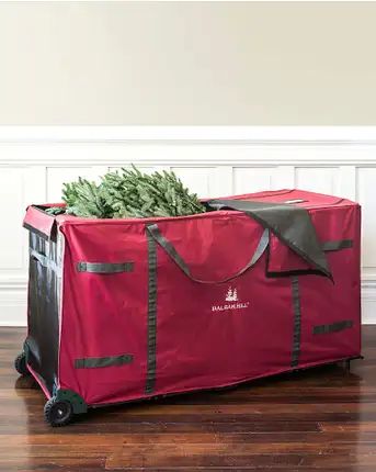 Store and protect your cherished Christmas decorations for many seasons to come. With its spacious interior and wide access opening, this versatile storage bag can accommodate a large artificial tree, or a smaller tree along with wreaths and garlands. | Rolling Multipurpose Christmas Tree Storage Bag Christmas Tree Storage Bag, Wreath Storage, Christmas Tree Storage, Ornament Storage, Balsam Hill, Wreaths And Garlands, Christmas Greenery, Smart Storage, Christmas Storage