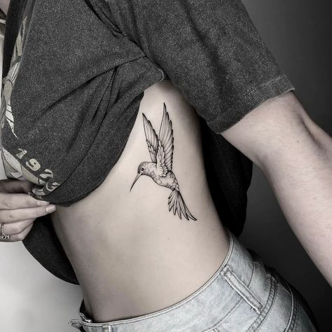 50 Beautiful Hummingbird Tattoo Ideas for Men & Women in 2024 Hummingbird Tattoo Sternum, Hummingbird Side Tattoo, Angel Hummingbird Tattoo, Hummingbird Tattoo On Leg, Below Chest Tattoo Female, Woman Inner Bicep Tattoo, Wildflower Hummingbird Tattoo, Humming Bird Shoulder Tattoos For Women, Hummingbird Tattoo On Ankle