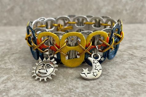 Enjoy this celestial sun and moon themed bracelet, handmade from recycled tabs off soda pop cans. The sun and moon charms are accented by blue and yellow pop tabs, and just a little bit of glitter.  Bracelets are strung with elastic cord for comfort, and can fold flat for storage or travel. Please choose your size at checkout: XS - 10 tabs, approx. 6 inches (child-size wrist) S - 11 tabs, approx 7 inches (small-boned wrist) M - 12 tabs, approx. 8 inches (medium-boned wrist) L - 13 tabs, approx. Tabs Soda, Soda Tab Bracelet, Pop Tab Bracelet, Tab Bracelet, Soda Tab Crafts, Can Tab Crafts, Soda Can Tabs, Pop Tab Crafts, Soda Can Crafts