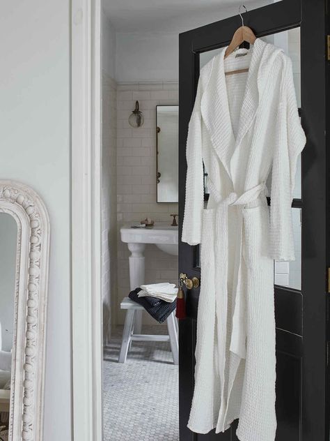 Create your very own Nordic spa at home with our gorgeous white waffle bathrobe, featuring a cosy hood and handy front pockets.A little everyday luxury goes a long way to improving our sense of wellbeing, which is why we've fallen in love with our wide-weave bathrobes and matching towels. They're highly absorbent and incredibly soft, making them a delight to use.Our crisp white linen-cotton waffle is reminiscent of a classic Scandi spa, yet durable and strong enough to use every day. This gender-neutral colour can be coordinated with our matching bath towel set or with our alternative bathrobe colours.Care instructions: machine wash at 40 degrees (max.), using a gentle cycle and mild detergent. Tumble dry on a low heat. Please don't use bleach-based products or stain removers to clean your Bathroom Revamp, Bathroom Ornaments, Scandi Furniture, Linen Bathrobe, Spa At Home, Nordic House, House Products, Spa Bathroom, Scandi Decor