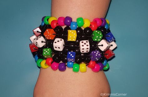 Rainbow and Black dice   Kandi  cuff  made with pony beads and stretch cord made with the X base  stitch cuff  Shipping please note I am UK based - It should take 3-7 days in the UK I ship first class Royal mail For international orders it can take 7 days to 4 weeks depending on where you are located please let me know if you have a deadline date. Scene Kandi, Bracelets Kandi, Pulseras Kandi, Kandi Cuff Patterns, Kandi Inspo, Diy Kandi Bracelets, Pony Bead Bracelets, Diy Kandi, Stitch Bracelet