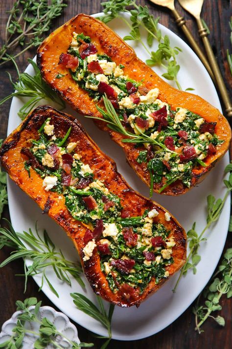 Stuffed Butternut Squash with Feta Cheese, Spinach, and Bacon - on a white platter. Stuffed Butternut Squash, Butternut Squash Spinach, Stuffed Butternut, Spinach And Bacon, Best Thanksgiving Side Dishes, Vegan Feta Cheese, Cheese Spinach, Butternut Squash Recipes, Thanksgiving Side