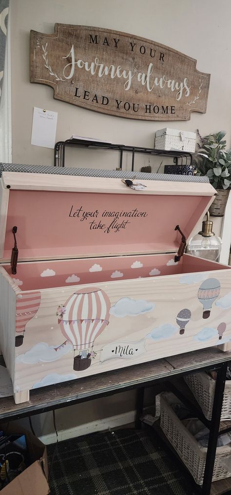 "DESCRIPTION:  This is a 32\" toy chest a 24\" rolling toy box or our new XL 38\" chest that is customized with the child's name on the banner.  The name is done in black    Lid quote is \"Let your imagination take flight\" it comes with this design.   A longer quote can be added under the lid for $14-$30  The toy box is hand crafted & It has a hand-painted Hot air balloon scene with elephant in the basket and roses on it. Hot air balloons are in pinks greys & cream. (Colors can be customized) W Painting Toy Chest, Toy Chest Bench Makeover, Toy Box Decoration Ideas, Toy Chest Painting Ideas, Vintage Toy Chest, Custom Toy Chest, Toybox Ideas Diy, Kids Toy Box Ideas, Painted Toy Box Ideas