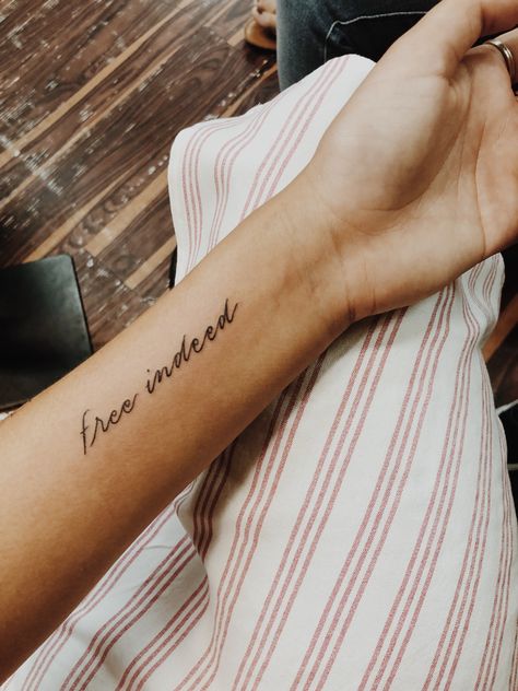 Free indeed tattoo Minimalistic Biblical Tattoos, The Word Free Tattoo, Loved By God Tattoo, Word Forearm Tattoos For Women, Free Indeed Tattoo, Free Tattoo Word, Be Free Tattoo Ideas, El Roi Tattoo, Forearm Tattoo Women Words