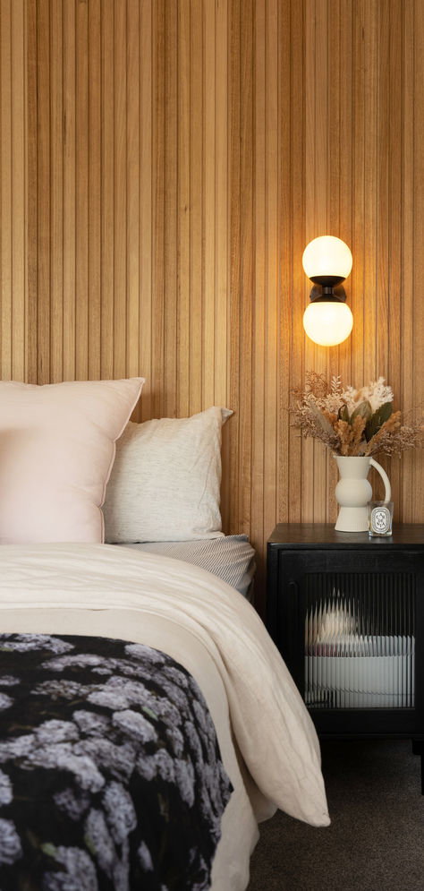 Rich vertical wood paneling creates a striking focal point in this stunning bedroom, offering a beautiful contrast against the dark furniture and decor. Visit our David Reid Homes bedroom inspiration gallery for more. Vertical Wood Wall Paneling, Vertical Wood Paneling, Walk In Robes, Dark Wood Paneling, Bedroom Inspirations Modern, Tranquil Bedroom, Wall Inspiration, Dark Furniture, Modern Masters