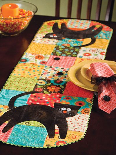 Use precut 5" squares in bright autumn colors and add black fabric for the cat and spiders for a fun table runner that will delight the young and the young at heart. This e-pattern was originally published in Jump-Start Your Quilting. Fall Runner, Fun Table Runner, Colchas Quilting, Table Runner, Cat Quilt, Table Runner And Placemats, Fall Quilts, Table Runner Pattern, Halloween Quilts