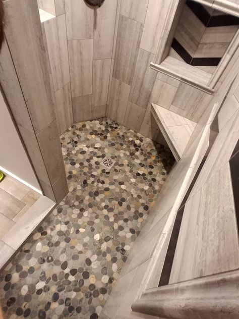 Gorgeous shower floor using Sliced Bali Ocean Pebble Tile...compliments the wall color and adds a pop. https://www.pebbletileshop.com/products/Sliced-Bali-Ocean-Pebble-Tile.html Rock Shower Floor, Pebble Shower, Pebble Shower Floor, Rock Shower, Pebble Mosaic Tile, Grey Rock, Pebble Tile, Gray Rock, Pebble Mosaic