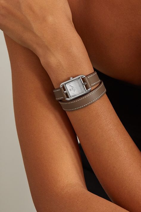 This elegant, minimal iteration of Hermès Timepieces' iconic 'Cape Cod' watch has a lacquered white dial traced with shimmering diamonds instead of the bold Arabic numerals you'll recognize from the original reference – only the 12 and six are marked out in rhodium-plated metal. Animated by a precise Swiss-made quartz movement, it has a stainless steel case in the square-within-a-rectangle shape that characterizes the style. The lugs are anchored by a hushed taupe leather 'Double Tour' strap, ma Hermes Cape Cod Watch Women, Hermes Cape Cod Watch, Hermes Watch Women, Cartier Jewellery, Hermes Watch, Hermes Style, Cartier Panthere, Brown Leather Watch, Hermes Jewelry