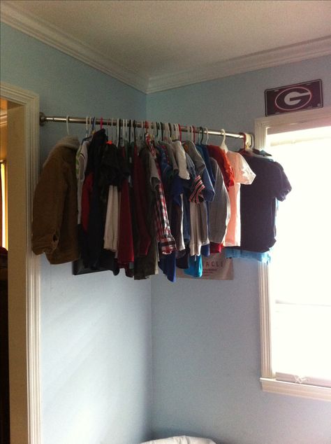 No closet? I used a curved shower rod for my son's clothes... Shower Closet, Corner Closet, Shoe Organization, Baby Clothes Storage, Diy Clothes Rack, Closet Curtains, Organization Closet, Tension Rods, Laundry Room Shelves