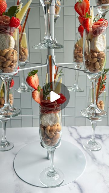 The Board Loon | Kelsey Bassett on Instagram: "Champagne Charcuterie Tower 🥂🧀
Found this champagne tower on Amazon and just knew I had to Charcuterize it. Charcuterize? I think I am making that a thing 😂 Anyway, turn heads at your next event by displaying your charcuterie this way. Buy two and have one for actual champagne too 😁 Comment the word Cheers and I’ll send the link to the tower! 

✨Follow along for more Charcuterie Boards, Midwest Accents, Tutorials, Recipes & more!
.
📬 : TheBoardLoon@gmail.com 
.
💻 : Www.TheBoardLoon.com
.
. @TheBoardLoon also on TikTok & Facebook
.
 #charcuterie #recipe #tutorial #theboardloon #cheeseboard #tutorial  #cheese #charcuterieboard  #appetizers #board" Food In Champagne Glasses Party Ideas, Champagne Charcuterie Cups, Charcuterie Tower, Appetizers Board, Recipe Tutorial, Champagne Tower, Shower Food, Charcuterie Boards, Champagne Glasses