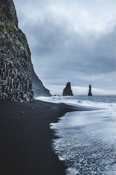 Reynisfjara, a beach of black sand and pebbles smoothed by the sea unique in the world, two majestic stacks emerge from the fog and then flow into the sea Iceland Beach, Iceland Honeymoon, Iceland Winter, Travel Finds, Peru Travel, Black Sand Beach, The Fog, Iceland Travel, Black Sand