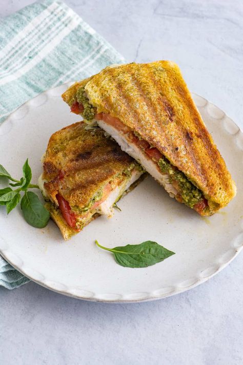 This grilled chicken Caprese pesto panini hot sandwich is what sandwich dreams are made of! Fresh ingredients piled into crusty sourdough bread - yum! | Hot Sandwich Recipe | Pesto Chicken Panini | Caprese Panini Recipe | Lunch Recipe | Easy Panini Recipe | Leftover Fried Chicken Recipes, Easy Panini Recipes, Avocado Panini, Chicken Pesto Panini, Pesto Mozzarella Chicken, Pesto Panini, Hot Sandwich Recipes, Feel Good Foodie, Chicken Panini