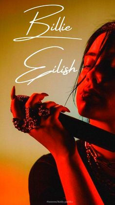 billie eilish wallpaper holding a mic and looking at her mic with her name writen in cursive billie eilish Billie Eilish Wallpaper, Billie Eilish, A Woman, Pins