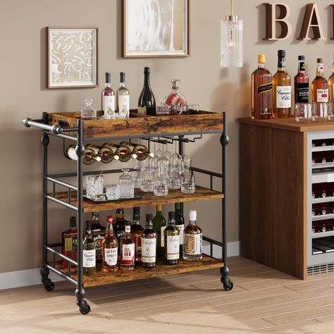 PRICES MAY VARY. Stylish Appearance Design: The vintage bar cart with unique roman column designs on the side pillars and handles, making the entire bar cart for the home more vintange and fashionable. The home bar & serving cart matches with your home decor easily in the living room, kitchen, or dining room. Large Storage Space: This bar cart is 15.7"D x 35.4"W x 34.1" H, comes with 3-tier shelves to store snacks, beverages, or kitchen supplies. The bar cart with wine rack and glass holders, wh Portable Home Bar, Rustic Bar Cart, Cart Bar, Snack Cart, Wine Cart, Living Room Retro, Bar Serving Cart, Wood Bar Cart, Metal Cart