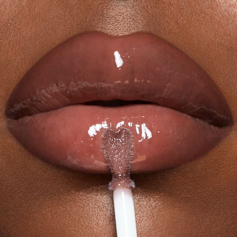 Sheer deep berry-rose lip gloss with skincare ingredients for a fuller-looking, high-shine pout! Cute Lip Gloss Tubes, Lip Gloss Photoshoot, Lip Gloss For Brown Skin, Lip Combo For Brown Skin, Ppg Buttercup, Charlotte Tilbury Collagen Lip Bath, Lip Gloss Aesthetic, Aesthetic Skincare Products, Lipgloss Aesthetic