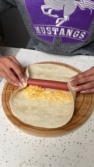 659K views · 5.6K reactions | Hot Dog Casserole | I found a new way to make hot dogs 😍 | By The Shaba Kitchen | Start by placing a hot dog in the center of a tortilla wrap. Then I'm going to take some shredded cheddar cheese and just add that on the side just like that. Then we're going to take the sides of our wrap. Fold them over onto our hot dog. And then we're just going to tuck and roll. And you should be left with something like this. Then we're going to place this in our casserole dish with the rest. Next I'm going to take some garlic butter. And then I'm just going to brush that on our tortilla wraps. Then we're just going to do a little bit on top of each one. Give it a little bit more flavor and help it get nice and crispy. Now it's time for a bit more cheese. I'm going to take Keto Hot Dog Casserole, Tortilla Hot Dog Wraps, Hot Dog Tortilla, Hot Dog Wraps, Mexican Hot Dogs, The Shaba Kitchen, Hot Dog Casserole, Baked Hot Dogs, Making Hot Dogs