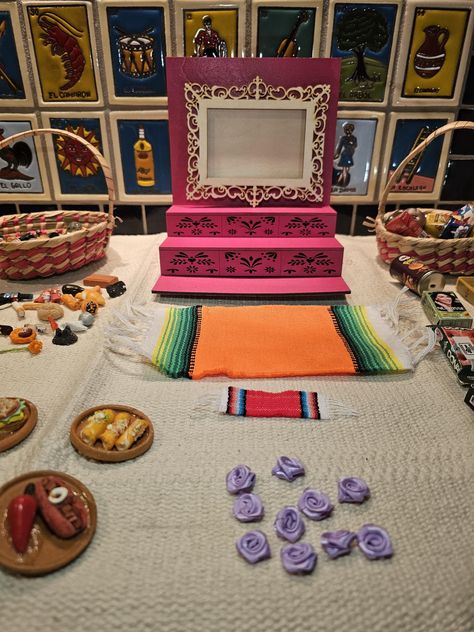 Celebrate the tradition of Dia de los Muertos with this customizable, handmade mini ofrenda kit. Perfect for creating a personal and unique altar to honor your loved ones. Package Includes: 1 Mini Ofrenda Frame (8"H x 7"W x 6"L) Color Options: Black, Red, Turquoise, Orange, Pink, Stained, and Natural.  1 Wallet-sized Picture Frame Gold color  1 Sarape (6"x2") Color Options: Dark Green, Bright Green, Blue, Orange, Pink, Purple, and White. 10 Mini Artesanías (Approx. 1" Diameter) Random Selection How To Make An Ofrenda, Offrenda Table Ideas Small, Small Ofrenda Ideas, Ofrenda Table, Ofrenda Ideas Diy Small, Ofrenda Ideas, Mini Ofrenda, Dia De Los Muertos Crafts Ideas, Dia De Los Muertos Party Ideas