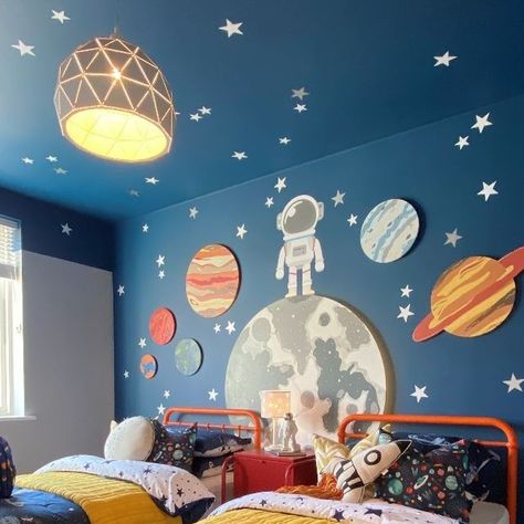 Artspace Interior Design LTD on Instagram: "Look at the space room in full effect 🤩🤩 the pops of bright colours in the furniture has helped to lift the darker colour on the walls and also kept it really fun! Design & Install: @artspaceinteriordesign . . . . . . . . #interiordesign #interiorstyling #interiors #kidsroom #spacetheme #twinroom #outthere #paintedceiling #newhome #showhome #planets #stars #spaceman" Dinosaur Space Bedroom, Toddler Space Bedroom, Space Toddler Room, Space Bedroom Boys, Kids Space Room, Kids Space Bedroom, Boys Space Room, Outer Space Room, Boys Bedroom Colors