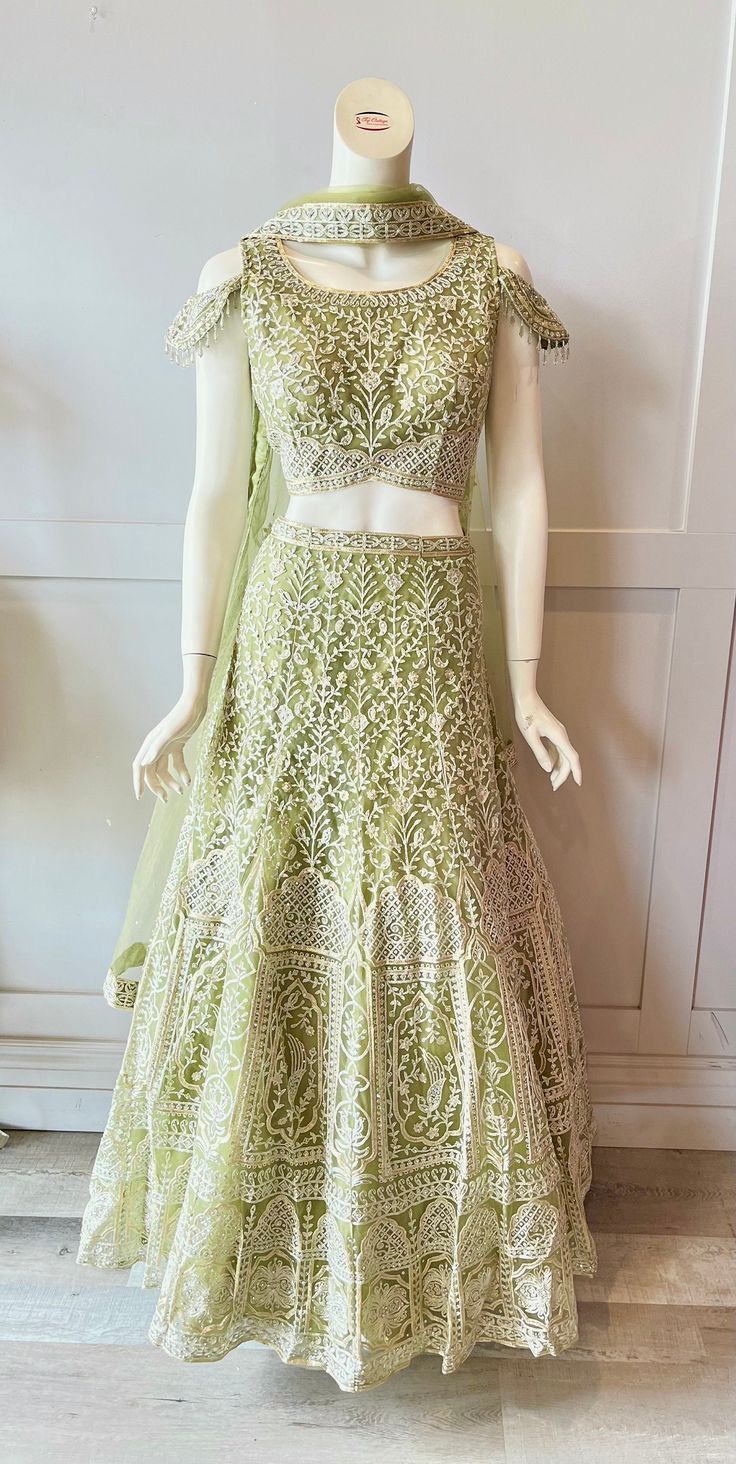 Lehnga details Fabric: Net Size: XLarge Waist : 38" Length : 44" Embroidery: Thread embroidery with rhinestones. Duppatta: Netted duppatta with thread work on it Pista Green Chanderi Choli With Intricate Embroidery, Intricate Embroidered Pista Green Chanderi Choli, Fitted Pista Green Anarkali Set With Intricate Embroidery, Pista Green Saree With Intricate Embroidery For Reception, Embroidered Pista Green Sets For Reception, Unstitched Pista Green Lehenga With Intricate Embroidery, Embroidered Pista Green Dola Silk Sets, Fitted Anarkali Embroidered Fabric In Chinon, Fitted Anarkali Embroidered Chinon Fabric