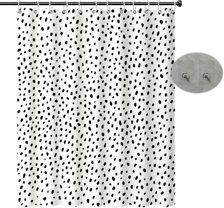 a shower curtain with black and white polka dot print on the outside, hanging from a metal rod