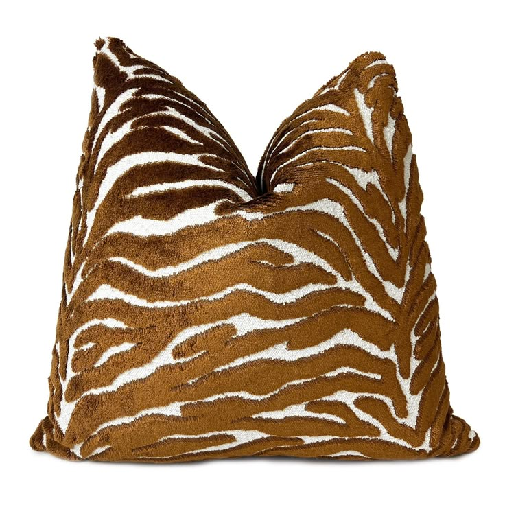 a brown and white zebra print pillow on a white background