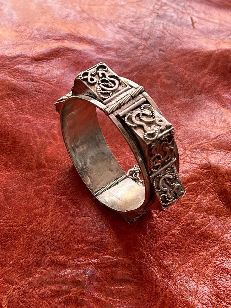 "Presenting a wonderful, vintage silver bracelet, BRACELET from North Africa, most likely Tunisia. The bracelet measures 13/16\" (2,05 cm) wide and its inner diameter is approximately 2 1/4\" (5,65 cm). It is hallmarked for 800 silver near the pin closure. The 3D effect is fantastic, adding amazing texture to the bracelet. It features raised \"spikes\" with \"Arabic\" letters on them along with twisted wire designs. This type of bracelet was made for export." Silver Bracelet Strap Jewelry For Festival, Silver Jewelry Bracelet Strap For Festivals, Silver Jewelry With Bracelet Strap For Festival, Adjustable Antique Sterling Silver Bracelet, Antique Sterling Silver Bracelets, Ornate Hallmarked Sterling Silver Bangle Bracelet, Ornate Hallmarked Sterling Silver Bangle, Antique Sterling Silver Bangle Bracelet, Vintage Sterling Silver Bangle In Antique Silver