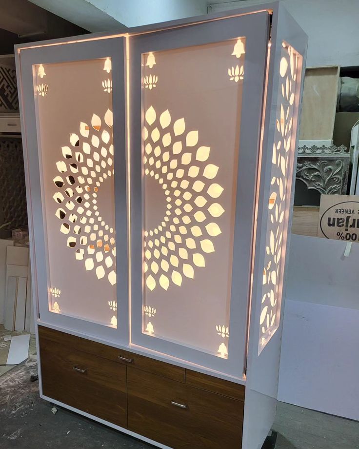 a white cabinet with lights on it in a room