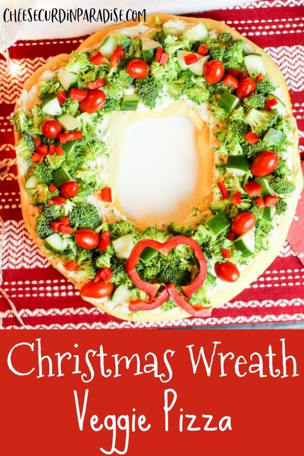 a christmas wreath veggie pizza on a red and white tablecloth with the words, christmas wreath veggie pizza