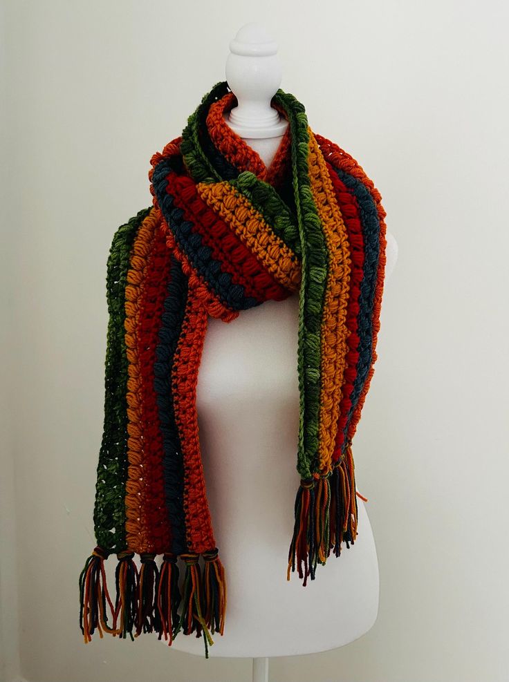 This boho extra long scarf is hand made with acrylic yarn and a variety of shades. This is a long scarf for the scarf lovers who like to wrap around your neck a couple of times. the scarf is  approx. 7 feet (90" long).   Want something a little different? I can definitely make you something with colors of your choice and length you would prefer. with or without the fringe.  The possibilities are endless ❤️ Warm Multicolor Scarves For Fall, Multicolor Yarn Shawl For Fall, Bohemian Multicolor Scarves For Winter, Handmade Multicolor Winter Scarves, Bohemian Knitted Acrylic Scarves, Bohemian One Size Acrylic Scarves, One Size Bohemian Acrylic Scarves, Bohemian One-size Acrylic Scarves, Bohemian Knitted Scarves In Acrylic Yarn