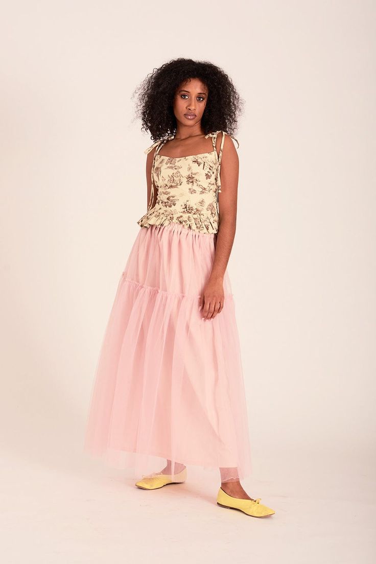 The Tilly skirt is back in the dreamiest ballet pink tulle. Made up of two floating tulle layers, the Tilly skirt has two tiers of gathered tulle, a stretchy elastic waistband, and is lined with a sturdy and soft cotton. - Soft pink two-tiered tulle skirt - 100% polyester- Lining is 100% cotton- Slips on and has an elastic waistband- Made in Canada- This tulle is super delicate. We suggest spot cleaning this with a warm cloth. * Ariam is 5'8 and wearing a size small * Rose is 5'8 and wearing a s Chic Pink Tulle Skirt, Feminine Fitted Tulle Skirt, Pink Tulle Maxi Skirt For Spring, Summer Tulle Maxi Full Skirt, Summer Tulle Maxi Flared Skirt, Summer Flared Tulle Maxi Skirt, Summer Tiered Flowy Tulle Skirt, Pink Fitted Tulle Maxi Skirt, Long Tulle Skirt For Spring