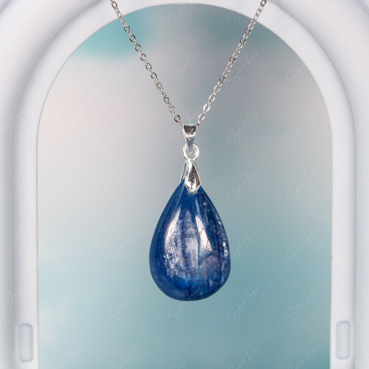 This elegant blue Kyanite teardrop pendant necklace is like a raindrop from heaven, the stone has a beautiful texture in blue green color. It's simple, yet elegant, and will be a great accent on your everyday outfit. Experience the beauty of nature with this stunning blue Kyanite pendant necklace! The unique teardrop design and vibrant blue-green color make it a truly eye-catching piece. Elevate any outfit with the simple yet elegant touch of this luxurious necklace. Each time you wear it, you'l Blue Teardrop Gemstone Crystal Necklace, Blue Gemstone Teardrop Pendant Necklace, Blue Teardrop Pendant Necklace With Natural Stones, Sapphire Teardrop Pendant Jewelry, Sapphire Teardrop Jewelry With Natural Stones, Teardrop Sapphire Jewelry With Natural Stones, Blue Natural Stones Teardrop Pendant Necklace, Sapphire Teardrop Gemstone Necklace, Blue Teardrop Crystal Necklace For Gifts