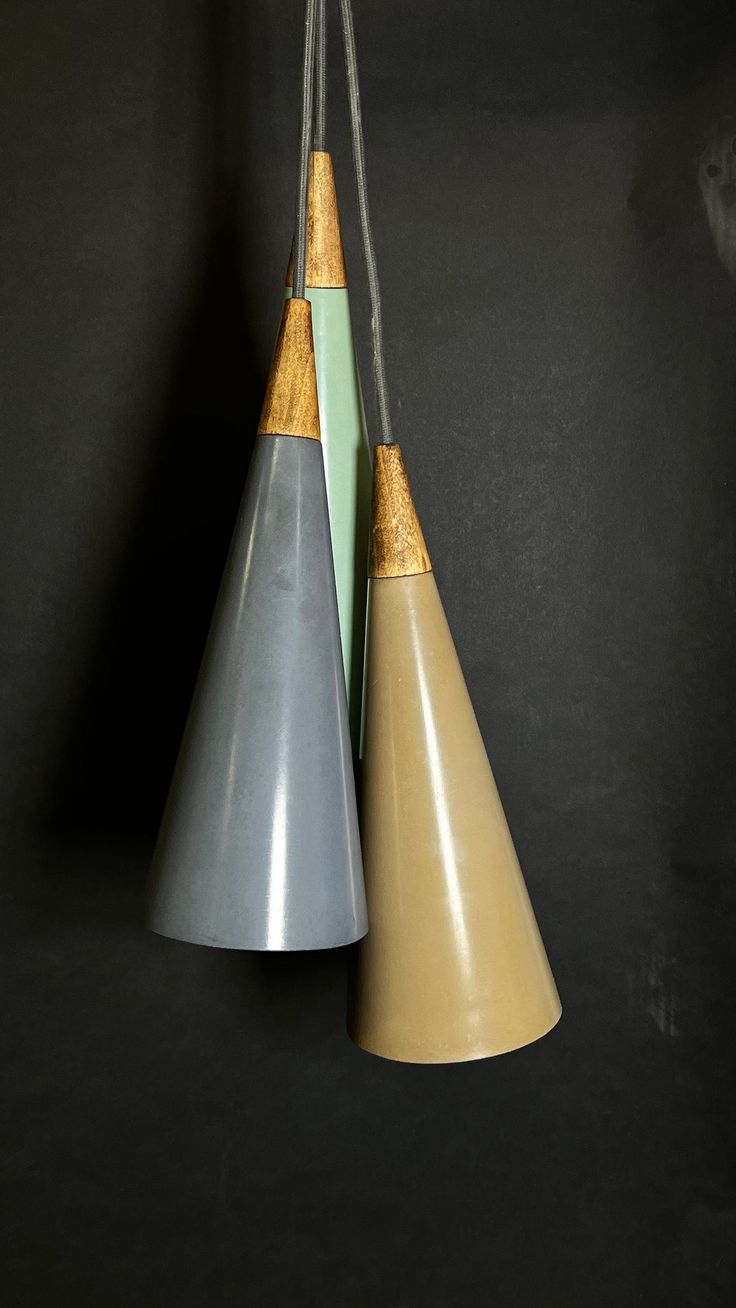 three different colored cones hanging from strings