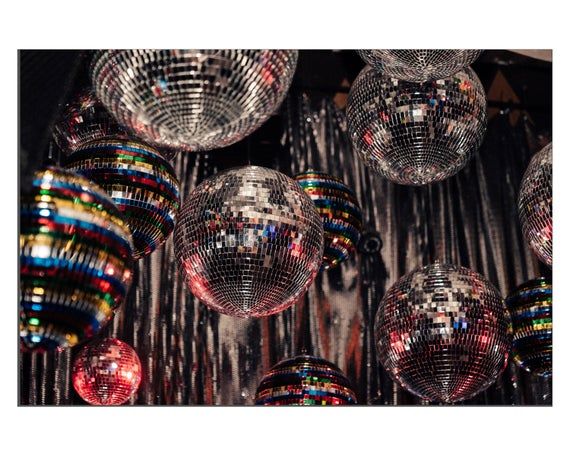 many disco balls are hanging from the ceiling