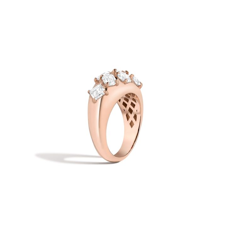 a rose gold ring with three diamonds on the top and bottom, set against a white background