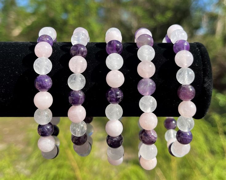 Amethyst Clear Quartz And Rose Quartz Combo is a harmonious symphony of crystal energies. With its combination of amethyst, clear quartz, and rose quartz beads, it becomes a wearable embodiment of balance and affection. It's not just an accessory; it's a reminder to align your energies and amplify your intentions. Highlights: Handmade item Bracelet length: 7.5 Inches Materials: Crystal Gemstone: Amethyst Spiritual Rose Quartz Crystals With Natural Stones, Spiritual Rose Quartz Crystals, Elegant Amethyst Crystals For Healing, Pink Amethyst Crystal Bracelet For Healing, Purple Rose Quartz Jewelry For Healing, Rose Quartz Beads, Quartz Beads, Energy Crystals, Crystals And Gemstones