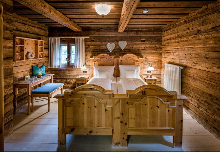 a bed in a room with wooden walls