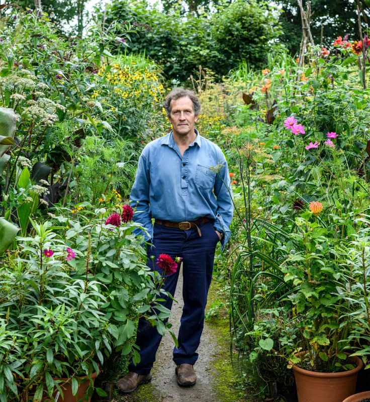 a man standing in the middle of a garden