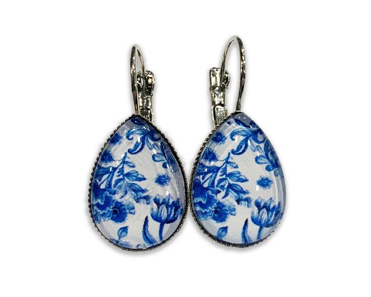 Delft blue earrings earrings are crafted one at a time in my home studio and are available in stainless steel or bronze. The blue botanical earrings are composed of a quality printed image and protected with a pure, crystal clear glass cabochon that protects the printed art underneath. It will show your unique style and will go with everything. Makes a fabulous and unique gift for mom, birthday, Christmas, Valentine... You may also like : https://www.etsy.com/shop/MeGustaMuchoShop?ref=seller-pla Blue Enamel Flower Earrings As Gift, Blue Floral Print Earrings For Gift, Blue Porcelain Earrings, Elegant Blue Pressed Flower Earrings, Delft Blue Earrings, Botanical Earrings, Unique Gifts For Mom, Delft Blue, Printed Art