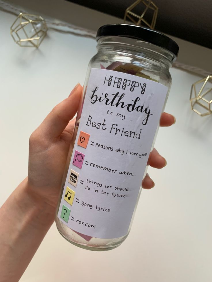 a person holding up a jar with some kind of message on it that says happy birthday to my best friend