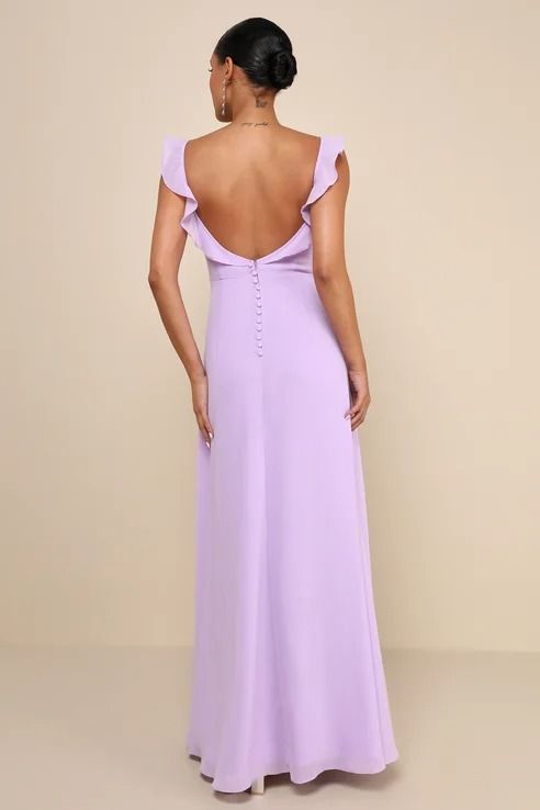 the back of a woman wearing a lavender colored dress with ruffled shoulders and an open shoulder