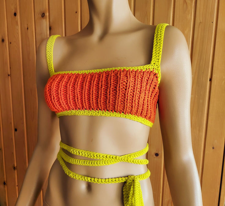 Cropped Bralette Crochet Rave Top Outfit, Orange Yellow Halter Knit Tank Top Orange Crochet Beach Top For Spring, Orange Crochet Top For Beach And Spring, Yellow Halter Neck Top For Festival, Yellow Halter Neck Crop Top For The Beach, Orange Halter Neck Tank Top For Summer, Stretch Orange Tank Top For Beach, Orange Sleeveless Crochet Top, Stretch Orange Tank Top For The Beach, Stretch Knitted Tank Top For The Beach