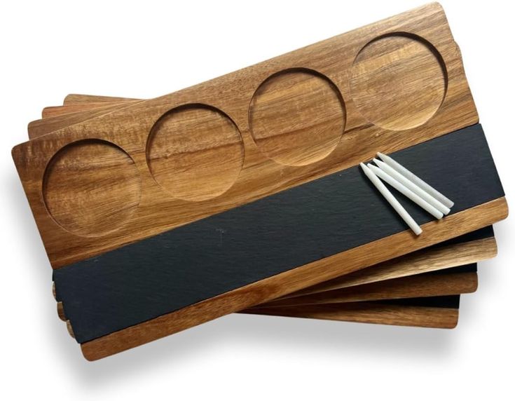 three chopsticks and two cheese boards on top of each other with black leather